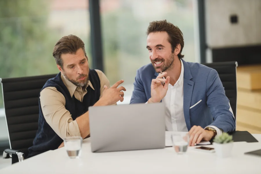 Two executives reviewing figures at a table